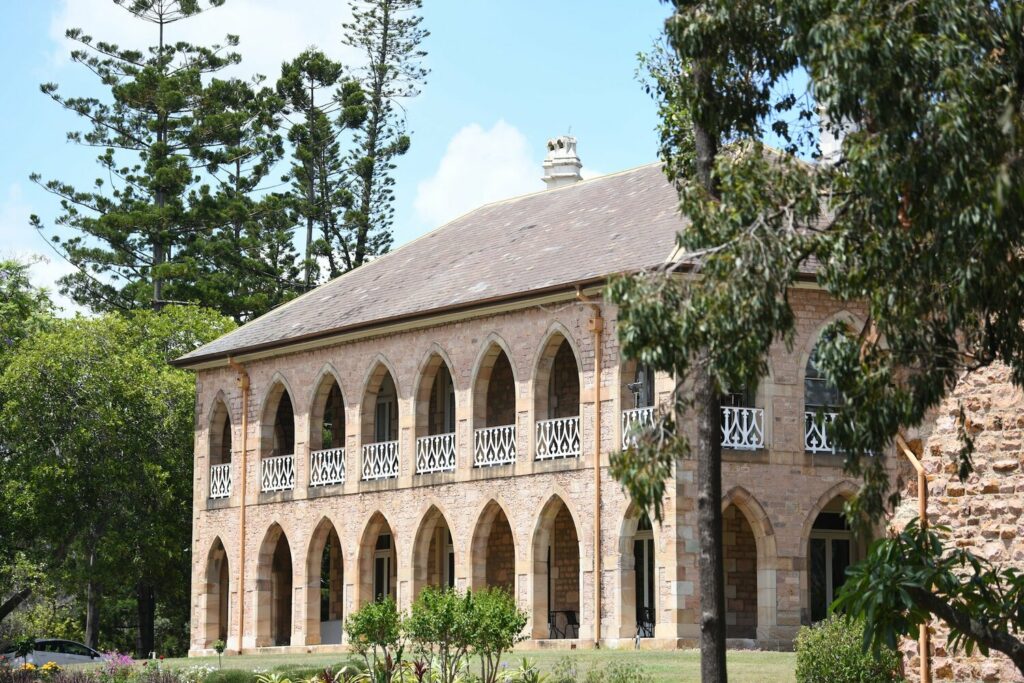 Photo of St Francis College two-storied stone building with multiple domed archways