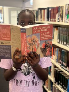 Young woman reading a book at the St Mark's library